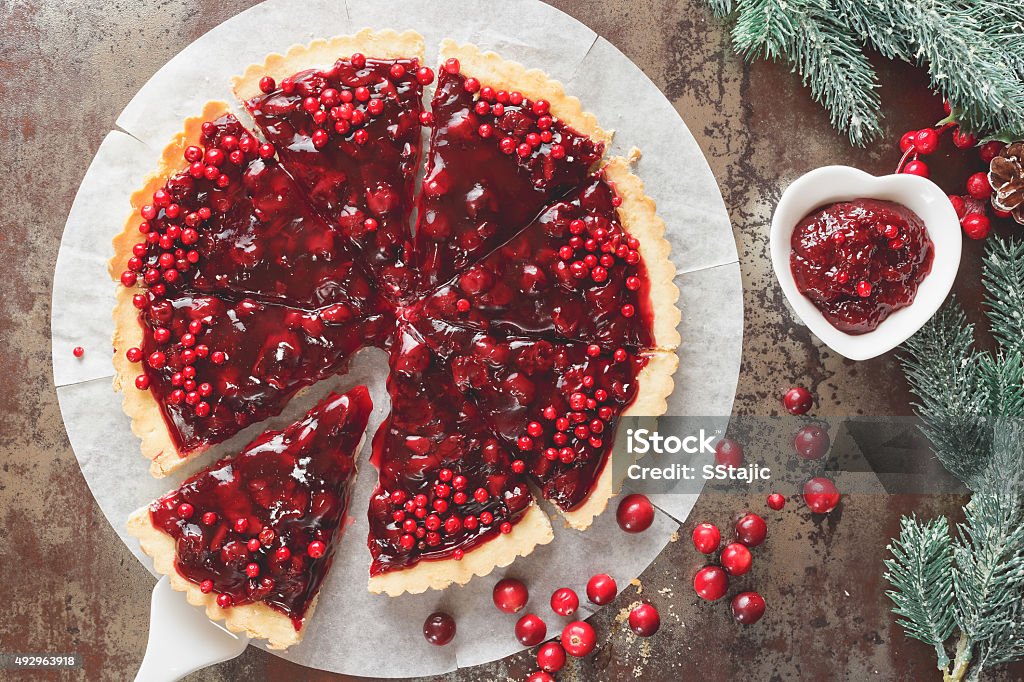 Cranberry Tart with browned butter crust  Delicious cranberry tart with jellied and fresh cranberries for Christmas. Top view, vintage toned  Sweet Pie Stock Photo