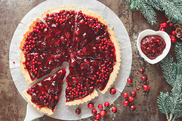 Cranberry Tart with browned butter crust  Delicious cranberry tart with jellied and fresh cranberries for Christmas. Top view, vintage toned  tart dessert stock pictures, royalty-free photos & images