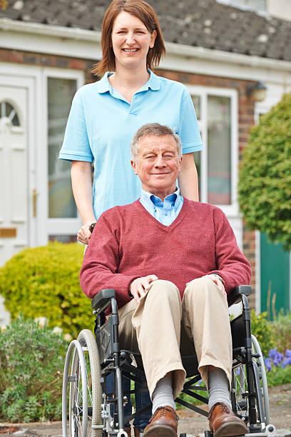 istock Carer With Senior Man In Wheelchair 492964323