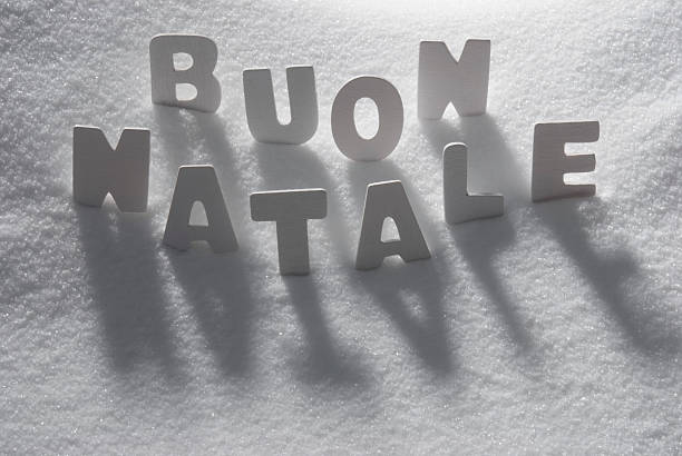 White Letters Building Italian Text Buon Natale Means Merry Christmas On White Snow. Snowy Landscape Or Scenery. Christmas Card For Seasons Greetings Or Usable As Background.