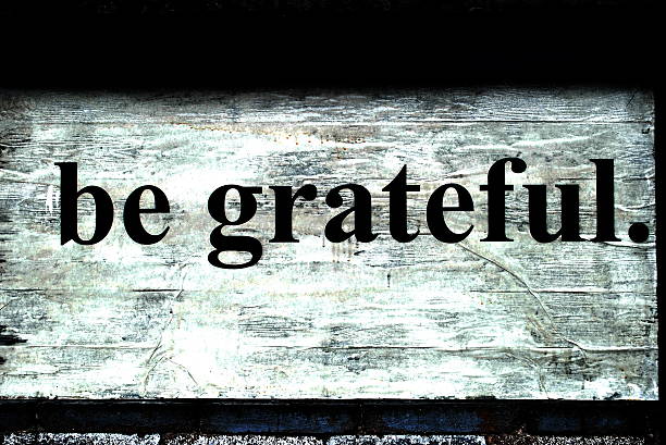 Be Grateful Found sign says the words "Be Grateful." Cracking paint, white background. truism stock pictures, royalty-free photos & images