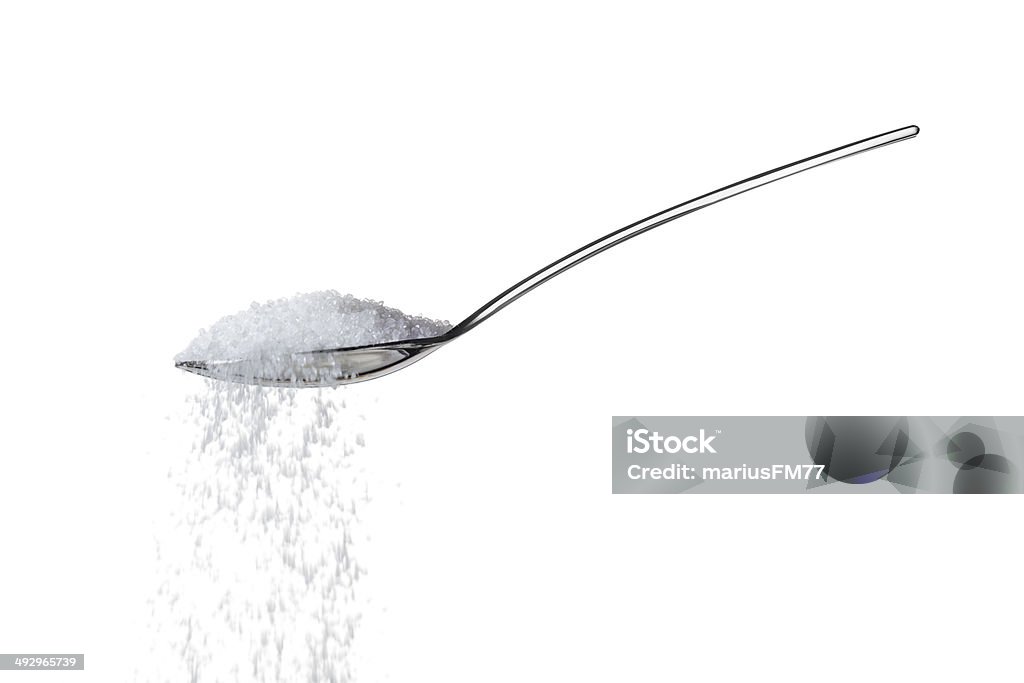 Sugar on teaspoon sugar/salt on teaspoon over white Sugar - Food Stock Photo