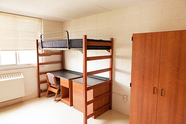 Empty University College Dorm Room with Bunkbed, Desk and Closet An empty university dormitory room with desk bed and closet. dorm room photos stock pictures, royalty-free photos & images