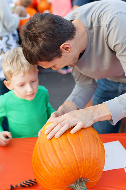 istock family carving pumpkin 492965912