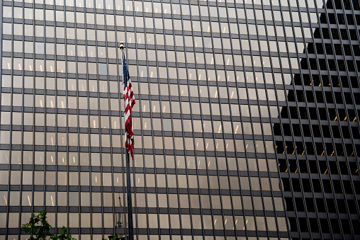 Flag in front of the Everett M. Dirkson Federal Courthouse in downtown Chicago Illinois, housing the U.S. District Court and the Seventh Circuit Court of Appeals