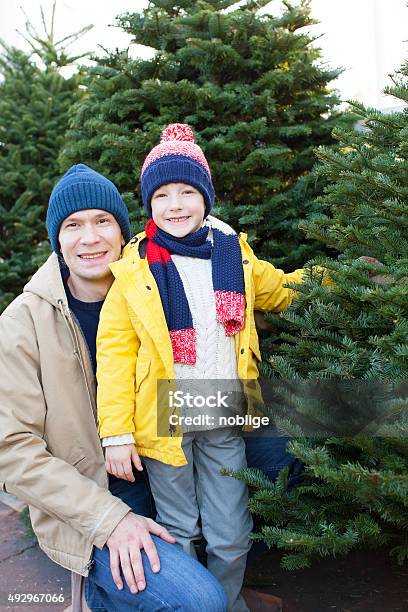 Family Shopping For Christmas Tree Stock Photo - Download Image Now - 2015, Adult, Business