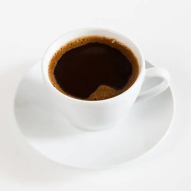 Photo of natural black coffee in a white cup