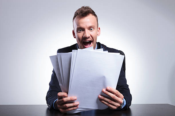 istock business man shocked by many bills 492969109