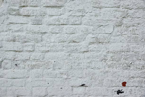 istock Retro Uneven Brick Wall With White Painted Plaster Background 492970426
