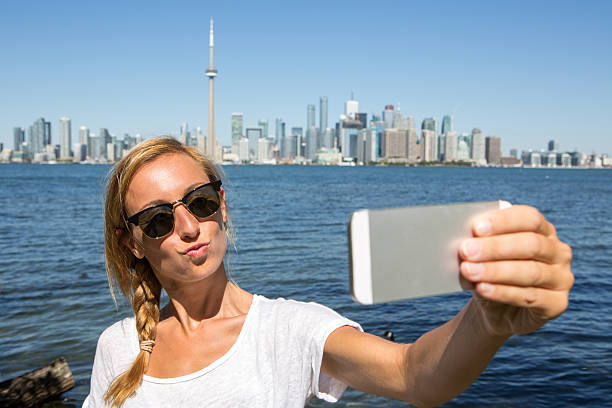 istock Girl taking selfie portrait in Toronto using mobile phone 492970554