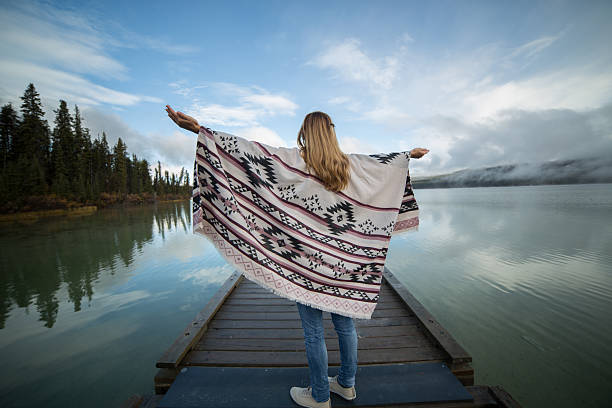 istock Young serene woman relaxing by the lake 492970568