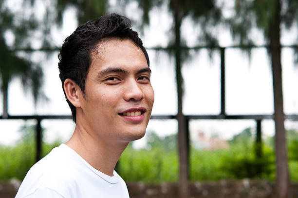 istock One asian man smiling at camara 492971464