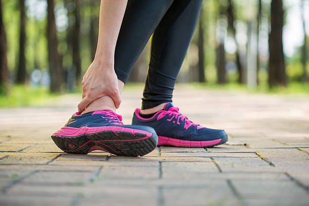istock woman runner hold twisted ankle Pain ,Human Leg 492982140