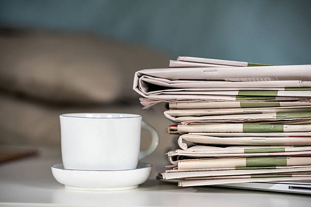istock Stack of newspapers and cup of coffee 492983584