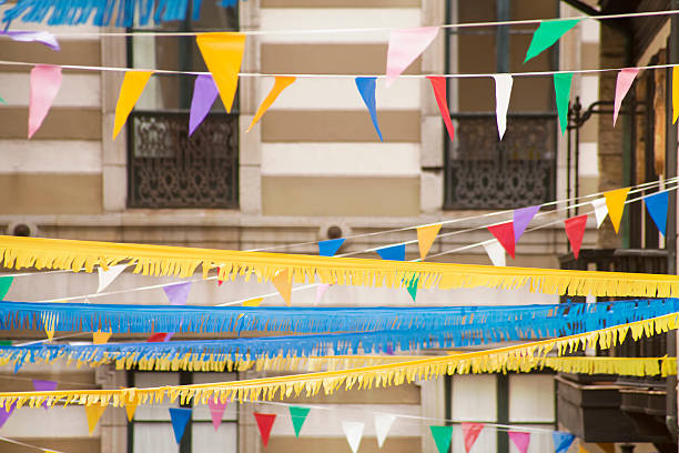 Multicolored feast decorations, streamers and bunting in the streets of old town Gijón, Cimadevilla, Asturias, Spain. 