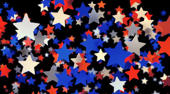 A group of tricolor star shaped confetti suspended in mid-air.