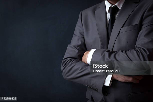 Businessman Standing Stock Photo - Download Image Now - Businessman, Arms Crossed, Crossing