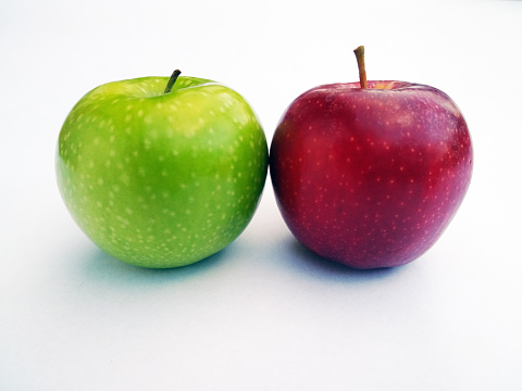 Red and green apple pair barely touching,