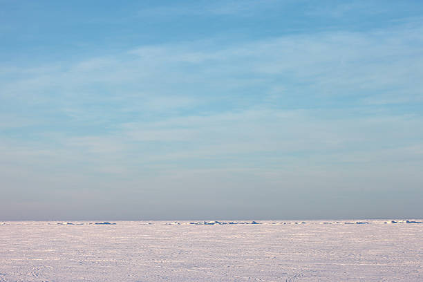 istock Snow plain and blue sky above a winter sea 492988620
