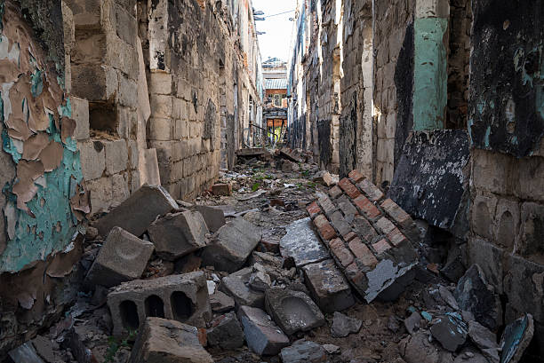 War-damaged building in Sloviansk, Ukraine The hallway of a building destroyed in the conflict in eastern Ukraine. This was part of a psychiatric hospital, scene of heavy fighting in 2014 in Sloviansk, Ukraine. eastern ukraine stock pictures, royalty-free photos & images