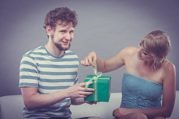 istock Young man giving woman gift box 492991612