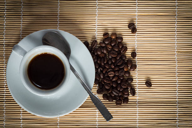 Hot morning coffee on a bamboo napkin in white porcelain dish