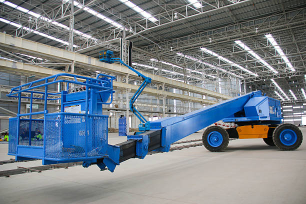 blue boom lift perspective indoor The atmosphere indoor of heavy industrial plants. mobile crane stock pictures, royalty-free photos & images