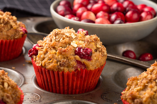 Freshly baked cranberry muffins with oatmeal crumble topping