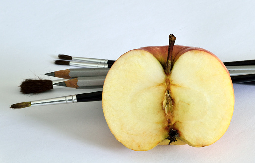Art apple with pencils and brushes