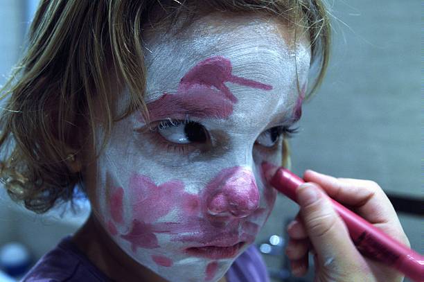 istock Girl painting the face 492993570