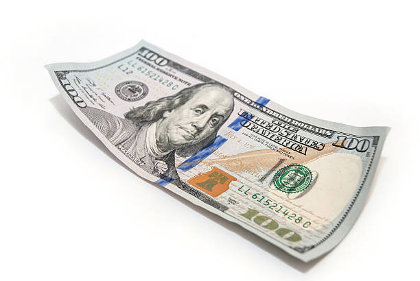 istock one hundred dollar closeup on white background 492994480