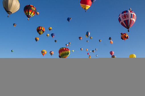 Albuquerque, New Mexico, USA  - October 10, 2015: A scene at the Albuquerque Balloon Fiesta 2015, one of the largest balloon events in the world. The fiesta is held yearly in October due to the weather phenomenon of the Albuquerque box which provides favourable conditions for hot air ballooning.  More than 500 balloons participate including the special shapes balloons.