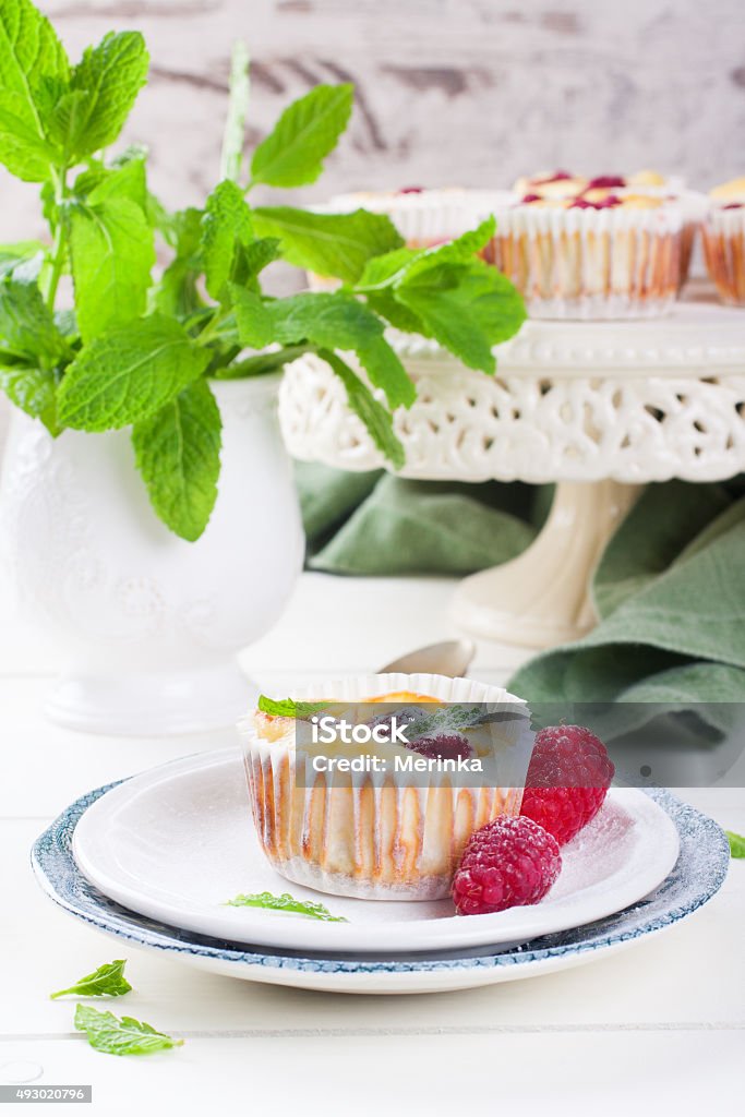 Ricotta mini cheesecake with fresh raspberries Ricotta mini cheesecake with fresh raspberries and mint leaves, baked in muffin forms. Selective focus. Healthy food concept. 2015 Stock Photo