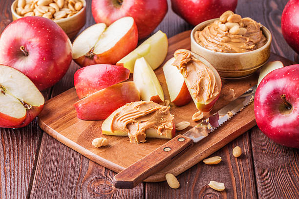 istock Red apples and peanut butter for snack 493021258