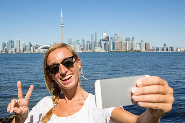 istock Tourist taking selfie portrait in Toronto 493021486