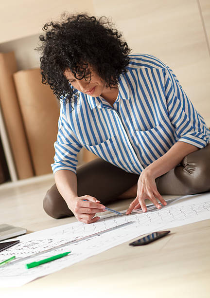istock Young female architect working at home 493022188