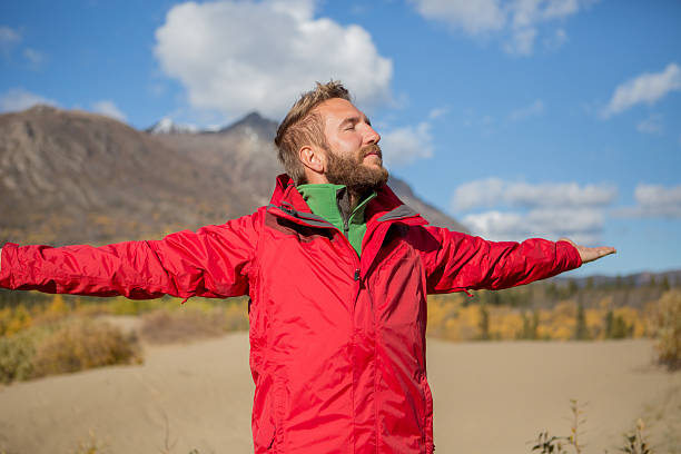 istock Man standing in desert arms outstretched for positive emotion 493022746