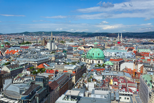 A view over central Vienna with Peterskirche (St Peter's Church) in the foreground, in the background the Rathaus (city hall) and Votivkirche (Votive Church) can be seen.