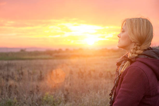 istock Young woman relaxing in a field 493023430