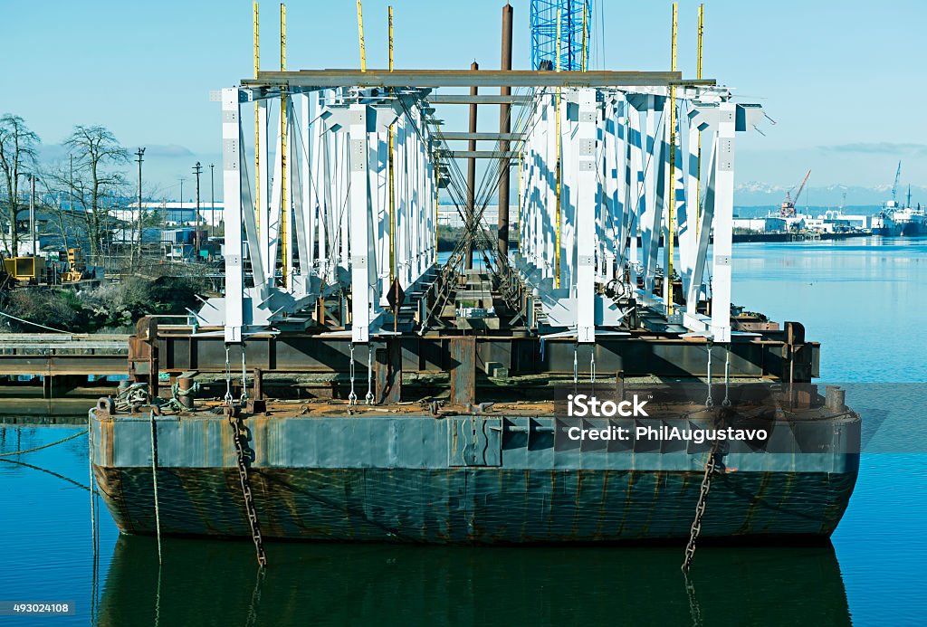 Bridge parts on barge in Tacoma WA Bridge parts to be shipped to Alaska on barge in Hylebos Waterway in industrial part of Tacoma WA  2015 Stock Photo