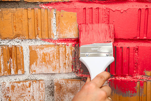 istock Hand with paint brush in red color 493025484