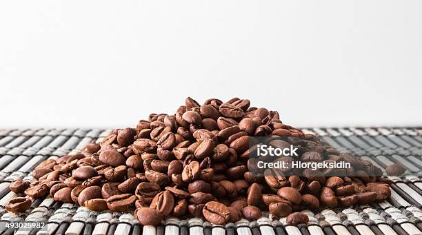 Heap Of Roasted Coffee Beans Lying On A Wooden Stand Stock Photo - Download Image Now