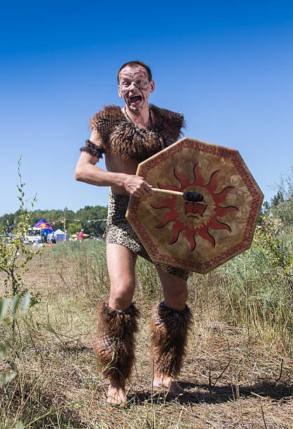 White male dressed in African aborigines with a tambourine at the festival of colors