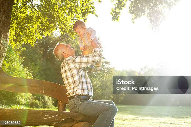 Grandfather With Grandson In Park Stock Photo - Download Image Now - Baby - Human Age, Grandfather, Senior Men