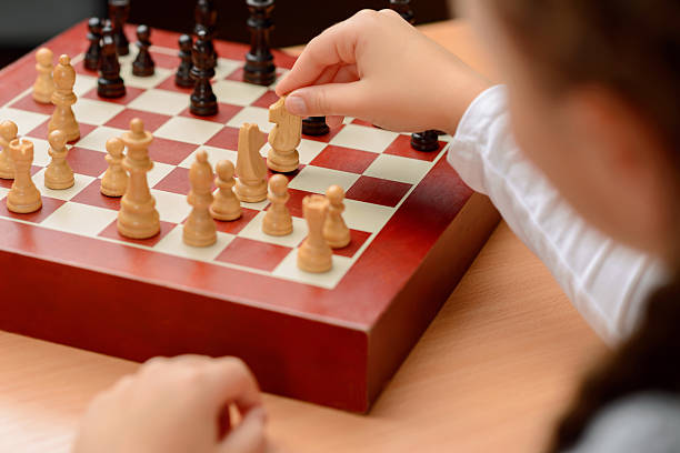 istock Grandfather playing chess with little girl 493031648