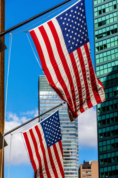istock Two bright american flags and the skyscrappers 493031912