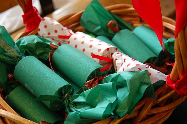 Basket of Christmas Crackers Red and green Christmas crackers in a decorative basket christmas cracker stock pictures, royalty-free photos & images