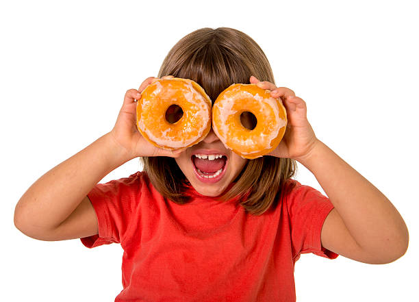 istock child playing with sugar donuts in the eyes smiling excited 493051778