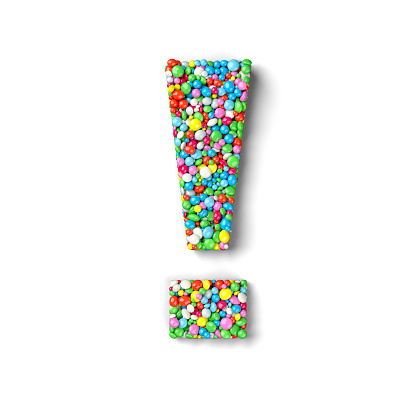 Exclamation mark coated with nonpareils of different colors isolated on white background