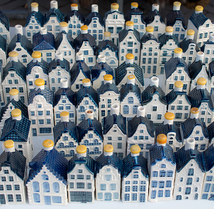 Small porcelain liquor bottles with yellow caps  in the shape of Amsterdam  canal  houses